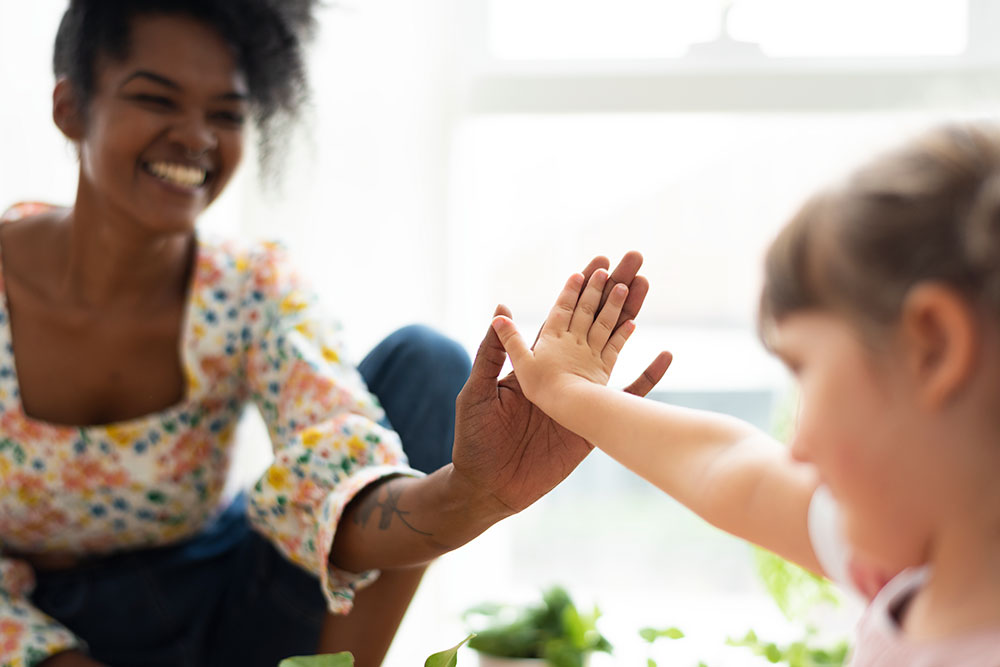 Image of a speech-language pathologist talking with a patient across a desk.